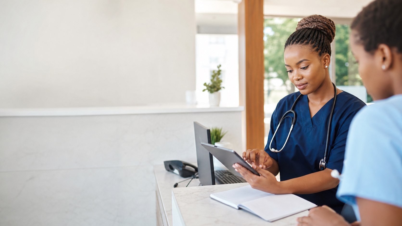 Healthcare professional reviewing patient information on a tablet